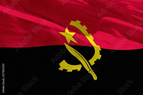 Waving Angola flag for using as texture or background, the flag is fluttering on the wind photo