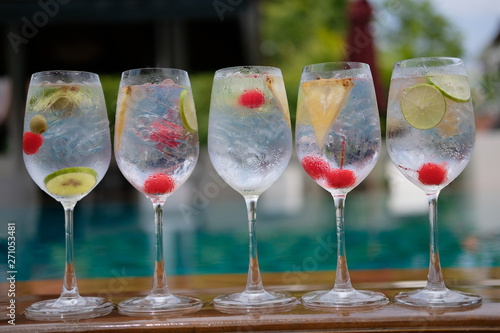 gin and tonic in wine glass at pool bar