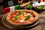Italian pizza Margherita on a wooden table