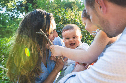 Happy Hispanic Family Having Fun Together Outdoors. © MCStock