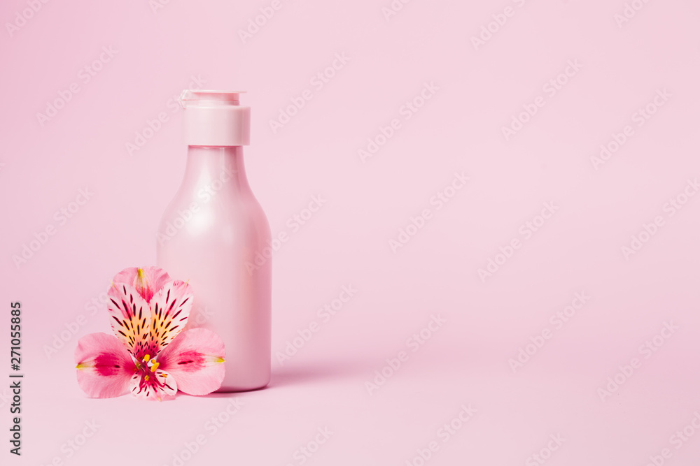 Creative minimal beauty and health background with pink bottle Creative minimal beauty and health background with pink bottle