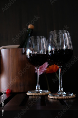 Close up wine glasses and bottles on wooden background