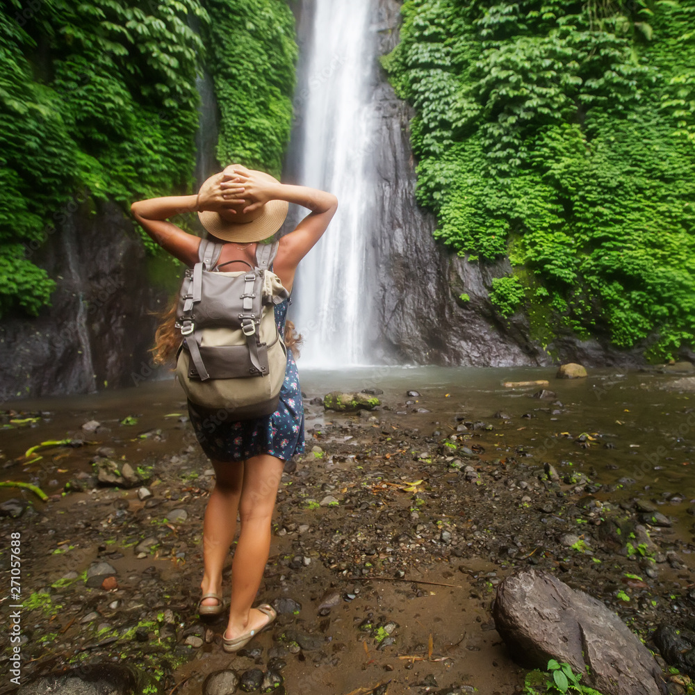 Woman near Munduk waterfal on Bali, Indonesia Woman near Munduk waterfal on Bali, Indonesia