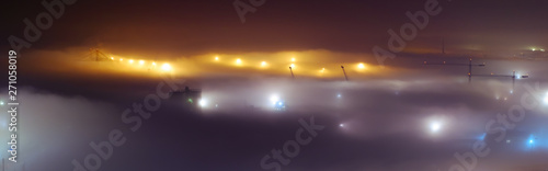 Misty night view in Malaga city port with crane