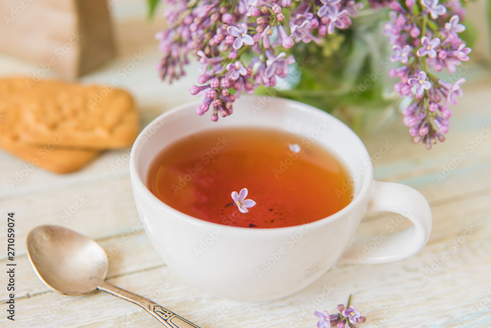Tea and blooming lilac, petal in a cup Tea and blooming lilac, petal in a cup