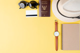 Top view travel concept with accessories on yellow background