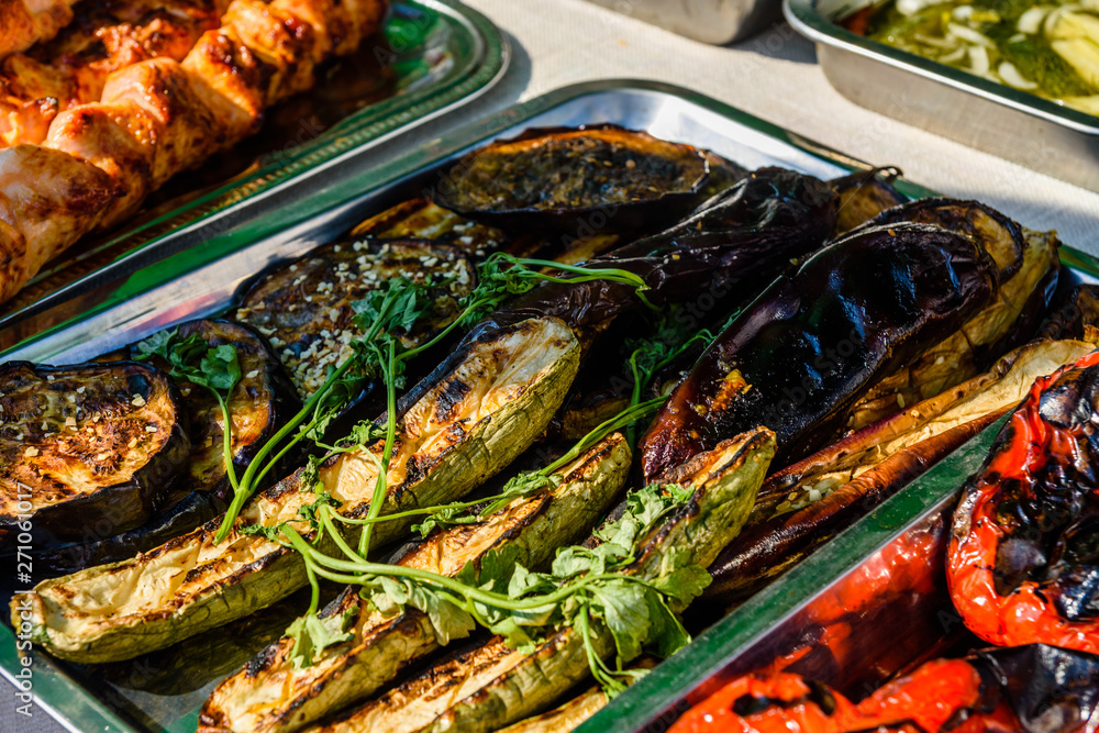 Grilled eggplants and marrows in a metal tray