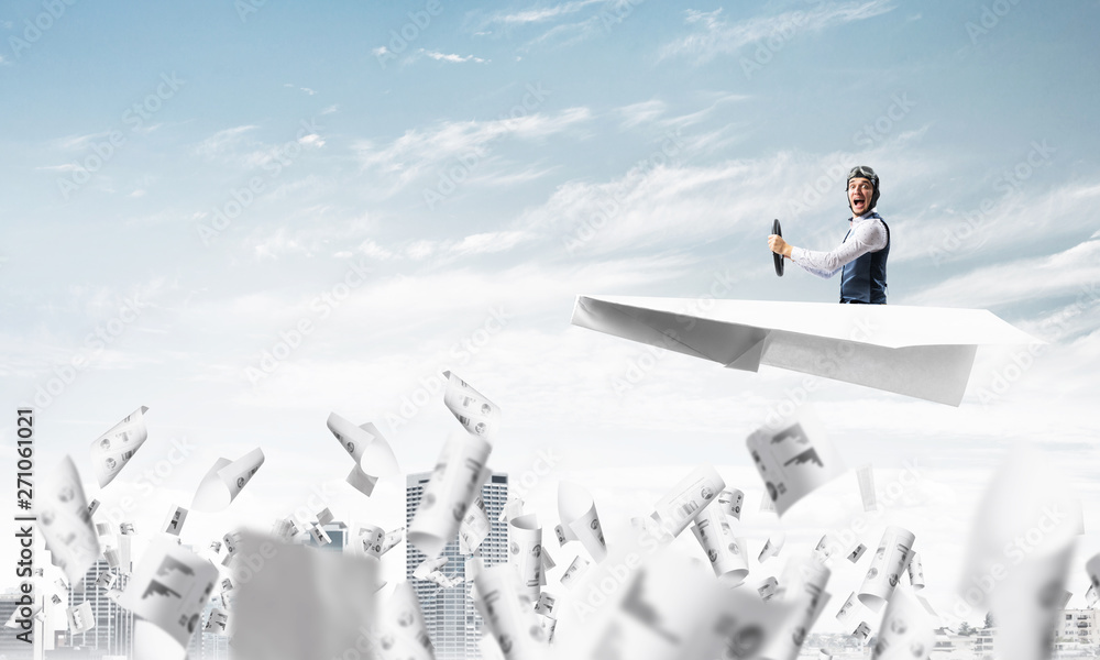 Aviator driving paper plane above business center Aviator driving paper plane above business center