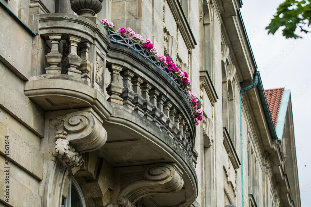 14.05.2019. Berlin, Germany. The old historical building on city streets with a beautiful balcony and pink bright flowers.