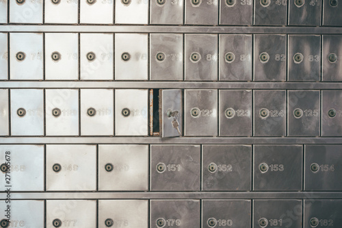 Private bank deposit box - close up of opened mailbox with a small key - post office box or PO BOX concept