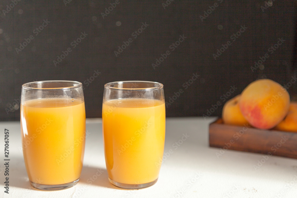 two peach juice glasses on black two peach juice glasses on black