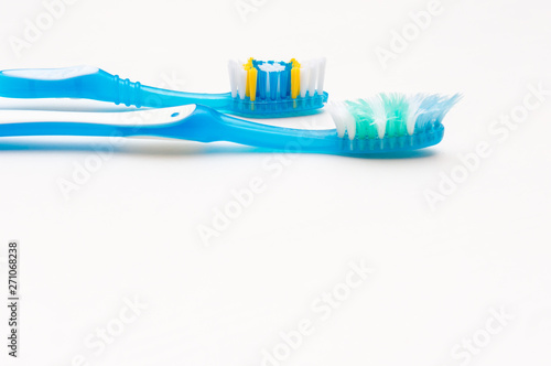 Old and new toothbrushes on a white background. The concept of healthy teeth. Oral hygiene. Place for text