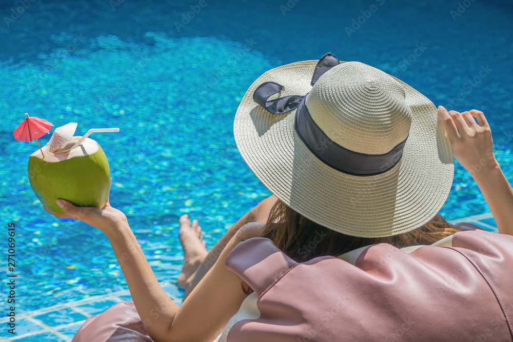 Obraz premium Women are relaxing at the poolside. woman relaxing in swimming pool spa. Cute girl is relaxing in the pool.Relax spa.