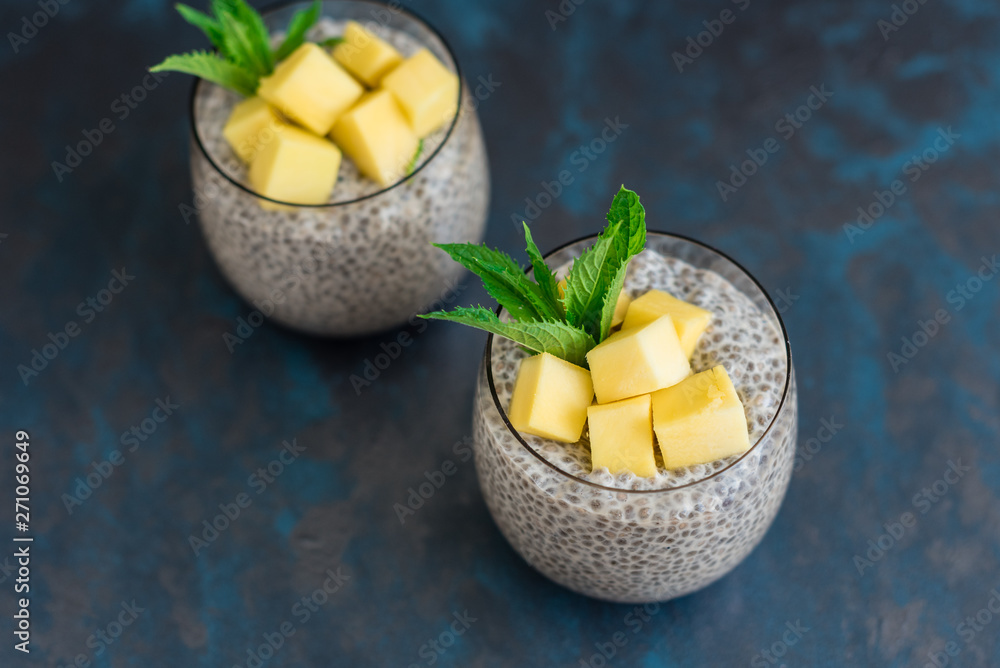Beautiful and tasty dessert with mango and seeds of a chia. A fresh pudding with fruit for breakfast Beautiful and tasty dessert with mango and seeds of a chia. A fresh pudding with fruit for breakfast