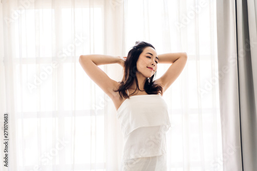 Woman stretching happy and relaxed after wake up in the morning at home Free Download Woman stretching happy and relaxed after wake up in the morning at home - GFXLoad