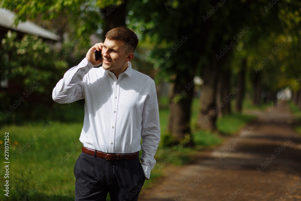 Businessman in the white shirt talking on the phone Businessman in the white shirt talking on the phone