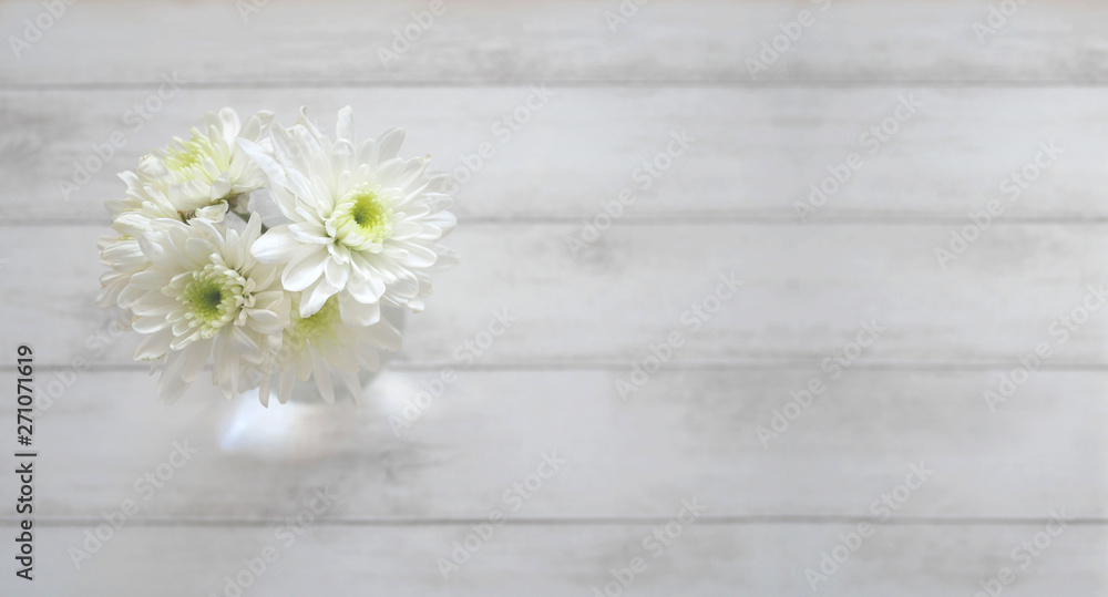 bouquet of white flowers on wooden background with copy space.