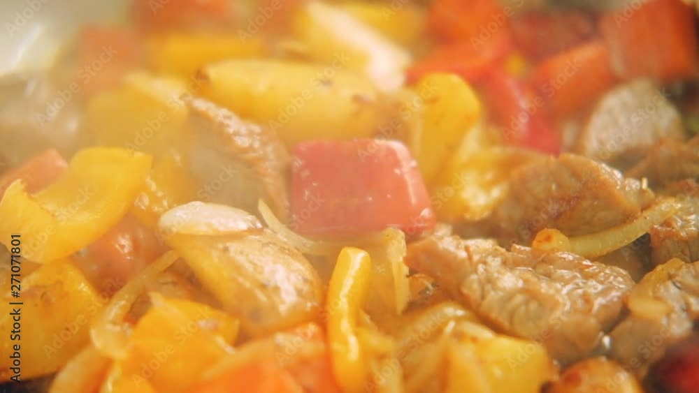 Stew preparation. Food cooking recipes. Fried meat and vegetables simmering in pan Stew preparation. Food cooking recipes. Fried meat and vegetables simmering in pan