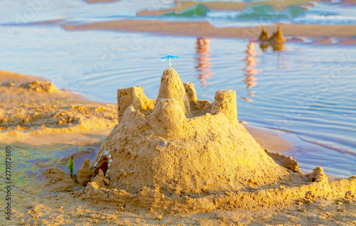 Sand castle on a tropical sea beach.
