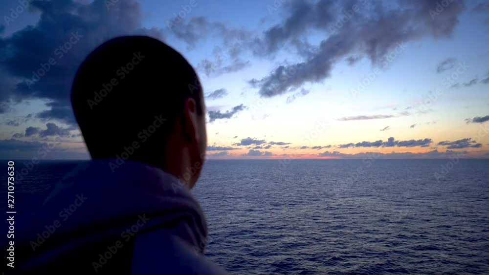 Closeup portrait man watching the dawn over the ocean