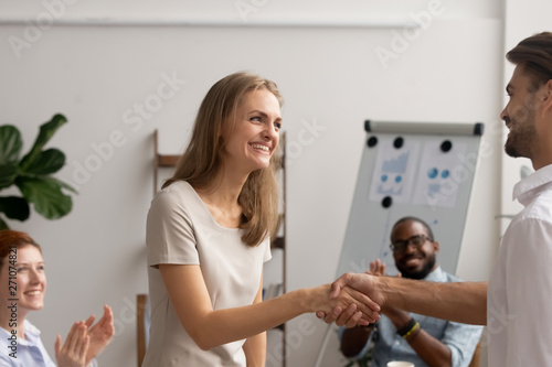 Young employee getting promotion handshaking with boss owner executive manager