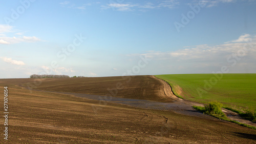Agrarian fields after heavy rain, deposits of chernozem and various debris on the field.