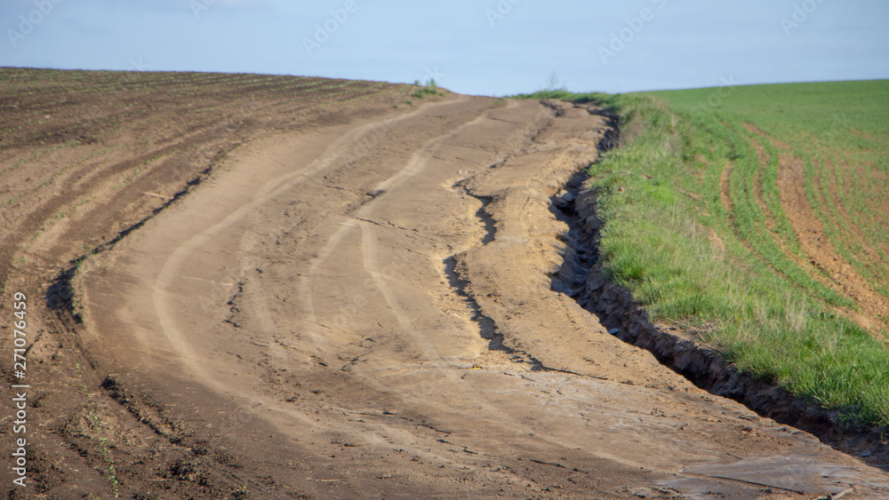 Agrarian fields after heavy rain, deposits of chernozem and various debris on the field.