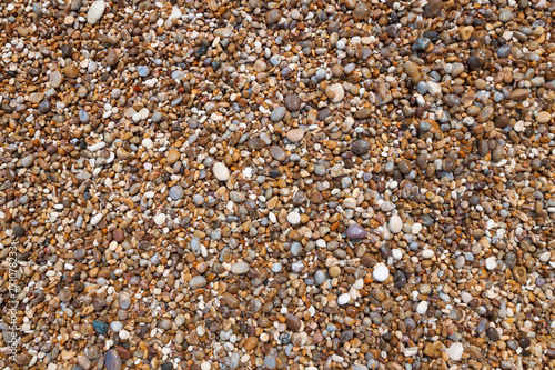 wet sea pebbles on the beach background