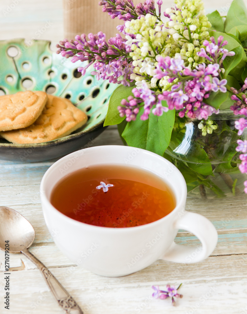 Tea and blooming lilac, petal in a cup Tea and blooming lilac, petal in a cup