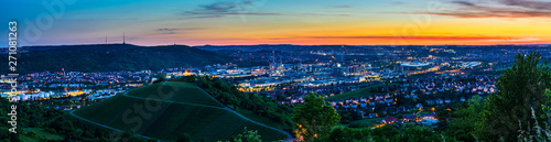 Germany, XXL landscape panorama of illuminated skyline of downtown city stuttgart at sunset from above in summer