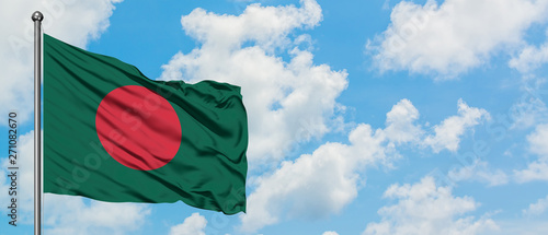 Bangladesh flag waving in the wind against white cloudy blue sky. Diplomacy concept, international relations.