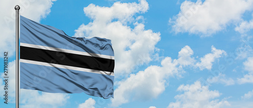 Botswana flag waving in the wind against white cloudy blue sky. Diplomacy concept, international relations.