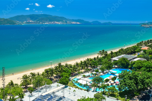 Aerial view at tropical resort on the beach with blue water and island in ocean