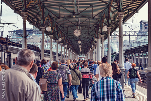 Crowd of people on the railway station after train arrival.