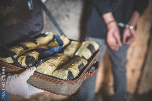 Police arrest drug trafficker with handcuffs. Law and police concept.  World Anti-drug Day
