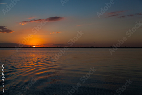 Sunset over water ripples