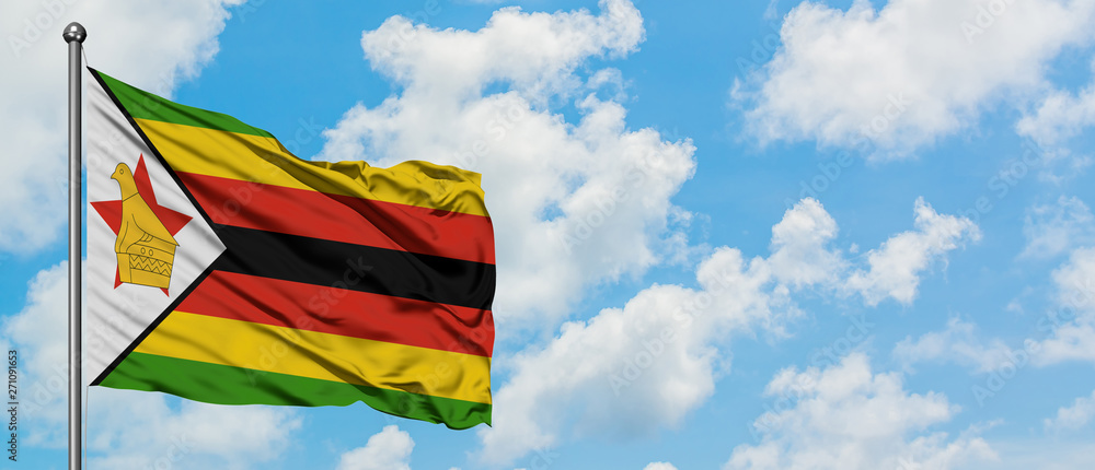Zimbabwe flag waving in the wind against white cloudy blue sky. Diplomacy concept, international relations. Zimbabwe flag waving in the wind against white cloudy blue sky. Diplomacy concept, international relations.
