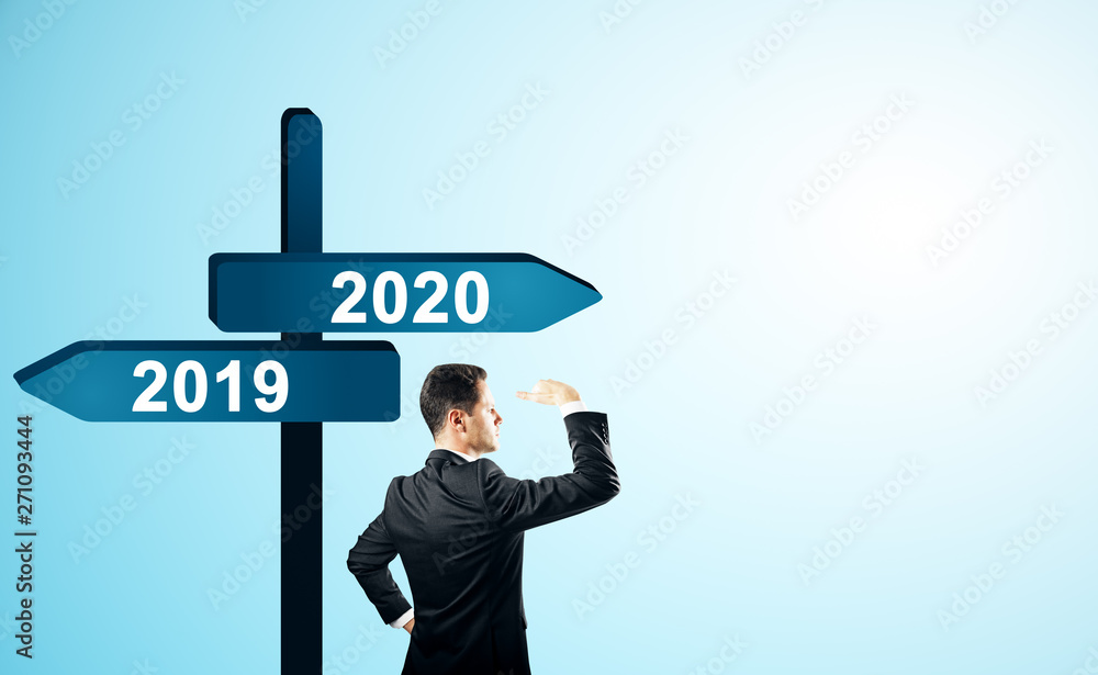 Man on 2019, 2020 sign Man on 2019, 2020 sign