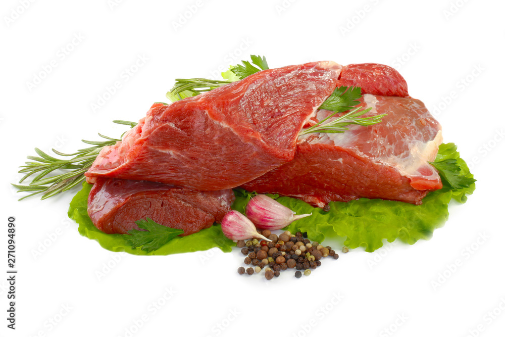 heap of steaks of beef with lettuce, garlic and pepeprcorn isolated heap of steaks of beef with lettuce, garlic and pepeprcorn isolated