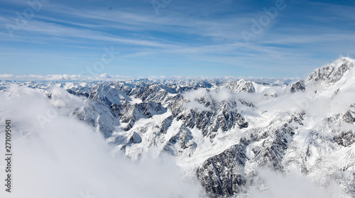 Panoramic view from a high point on the snow-covered mountain range. Mountain Altai. © Yuriy Pankratov
