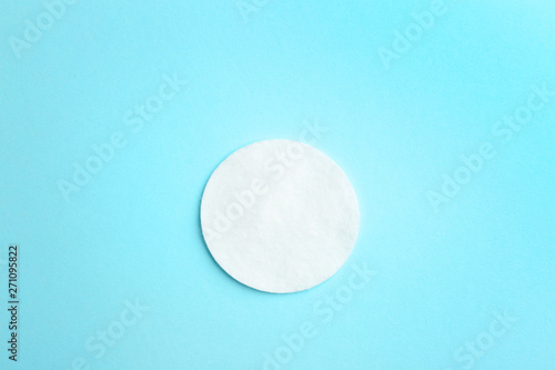 Cotton pad on color background  top view