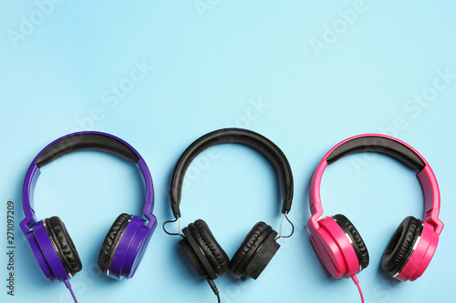 Stylish headphones on color background, flat lay. Space for text