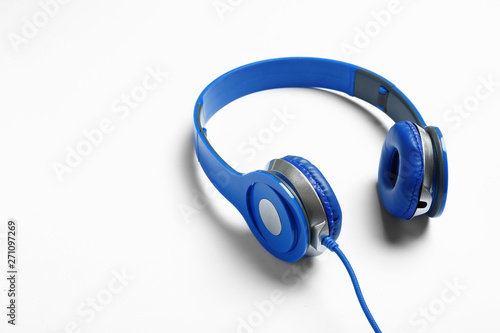 Stylish modern headphones with wire on white background