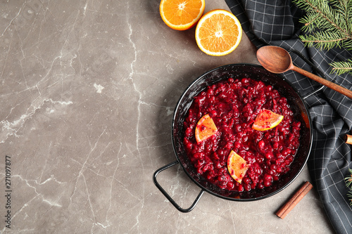 Flat lay composition with cranberry sauce in pan on table. Space for text