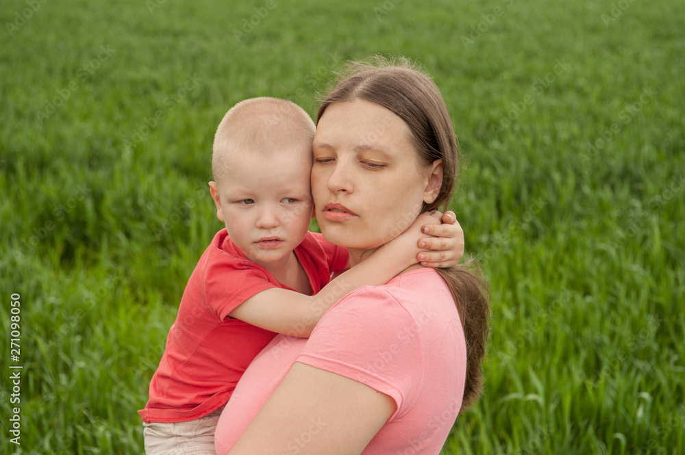 Happy mother with children playing on a green field with wheat..Unity with nature concept Happy mother with children playing on a green field with wheat..Unity with nature concept