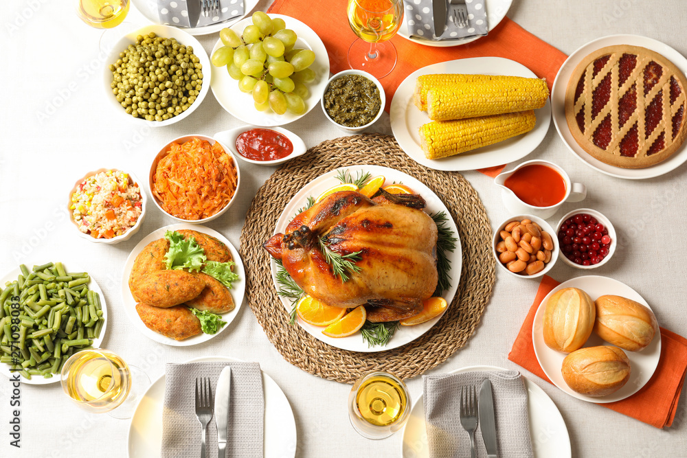 Delicious festive dinner with roasted turkey on table, flat lay Delicious festive dinner with roasted turkey on table, flat lay