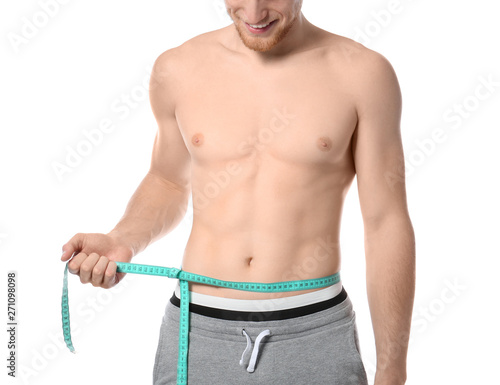 Young man with measuring tape showing his slim body on white background  closeup