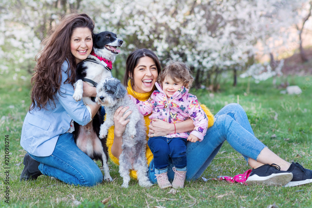Happy Family with Kid and Dogs in the Spring Park .Family Portrait with Dogs Happy Family with Kid and Dogs in the Spring Park .Family Portrait with Dogs