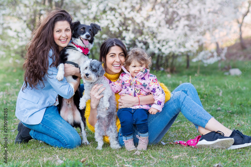Happy Family with Kid and Dogs in the Spring Park .Family Portrait with Dogs Happy Family with Kid and Dogs in the Spring Park .Family Portrait with Dogs