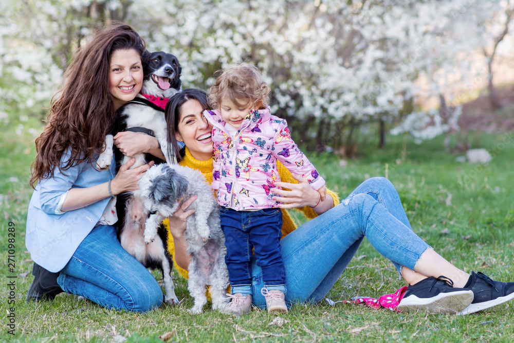 Happy Family with  Kid and Dogs in the Spring Park .Family Portrait with Dogs